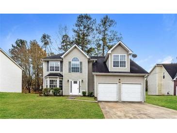 Charming two-story home with a two-car garage, well-maintained lawn, and classic curb appeal at 7071 Deshon Hills Ln, Lithonia, GA 30058