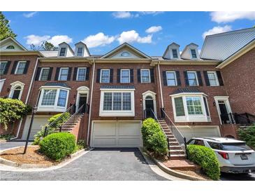 Charming brick townhome with well-maintained landscaping, private entrances, and attached garages at 1735 Peachtree Ne St # 624, Atlanta, GA 30309