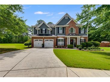 Charming two-story home with a well-manicured lawn and a spacious driveway leading to a two-car garage at 7115 Secret Rose, Douglasville, GA 30134
