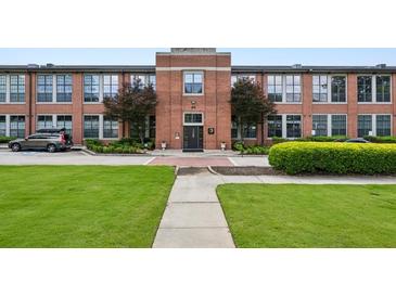 Charming brick exterior with manicured landscaping, sidewalk, and entrance at 1261 Caroline Se St # 108, Atlanta, GA 30307