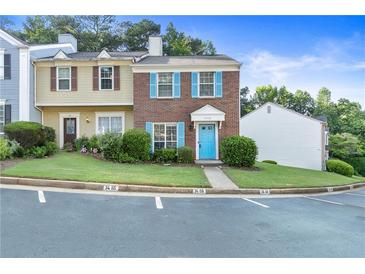 Charming townhome with brick facade, blue shutters, and a well-maintained front yard at 3468 Washington Way, Doraville, GA 30340