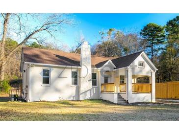 Charming single-story home with a welcoming front porch and nicely maintained landscaping at 5510 Mason Rd, Atlanta, GA 30349