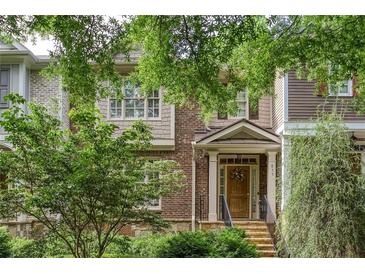 Charming brick townhome featuring a welcoming front porch and lush landscaping at 855 Mountain View Nw Ter, Marietta, GA 30064