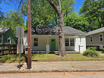 Charming home with a green door and well-maintained lawn at 112 Brown Se Ave, Atlanta, GA 30315