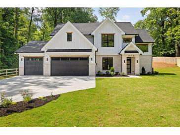 Beautiful two-story home with a three car garage, black framed windows, and fresh landscaping at 1870 Twin Branch Dr, Marietta, GA 30062
