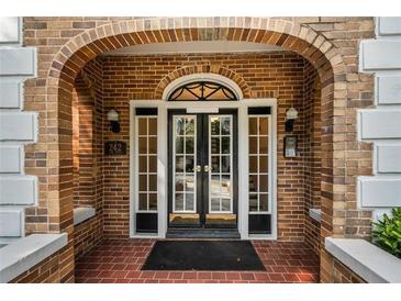 Charming brick entryway with double doors and arched details offers a warm and inviting welcome at 242 12Th Ne St # 1A, Atlanta, GA 30309