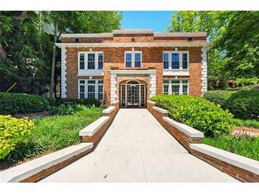 Attractive brick building with symmetric window placement and professionally landscaped entry at 242 12Th Ne St # 1A, Atlanta, GA 30309