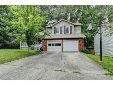 Charming two-story home featuring a two-car garage and a traditional brick and siding exterior at 2121 Crescentview Dr, Lawrenceville, GA 30044