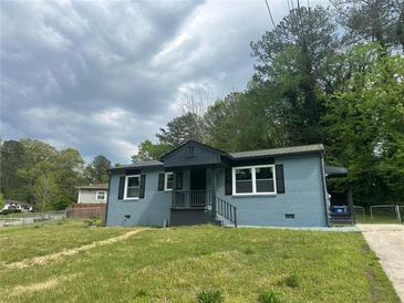 Charming single-story home with light blue brick, black trim, and a well-maintained front yard at 3730 Clovis Nw Ct, Atlanta, GA 30331