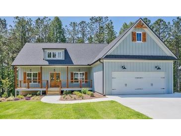 Charming, light blue, one-story home with a welcoming front porch and an attached two-car garage at 85 Presley Farm Pkwy, Rockmart, GA 30153