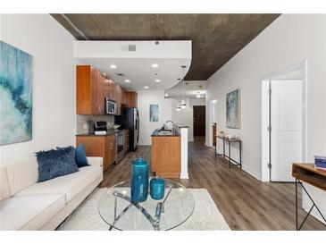Modern open floorplan with hardwood floors, modern cabinets and stainless steel appliances at 855 Peachtree Ne St # 1508, Atlanta, GA 30308