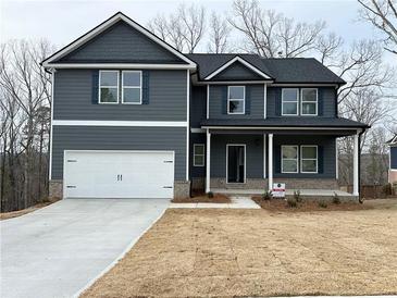 Charming two-story home with a two-car garage, inviting porch, and craftsman-style details at 5547 Bent Grass Way, Douglasville, GA 30135