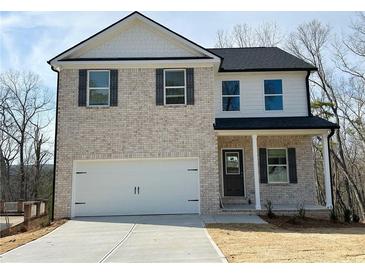 Charming two-story home featuring a two-car garage, light brick facade, and stylish black shutters at 18 Loth Wages (Lot 18) Rd, Dacula, GA 30019
