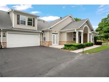 Charming home featuring a two-car garage, manicured landscaping, and inviting curb appeal at 2561 Grapevine Cir # 104, Cumming, GA 30041