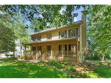 Charming two-story home with a welcoming front porch and manicured lawn at 2120 Habersham Trce, Cumming, GA 30041