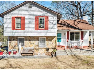 Charming home with stone accents, red shutters, and a welcoming front porch at 1040 Forest East Dr, Stone Mountain, GA 30088