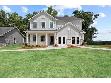 Beautiful two-story home with a well-manicured lawn and charming architectural details at 400 Beacon Way, Villa Rica, GA 30180