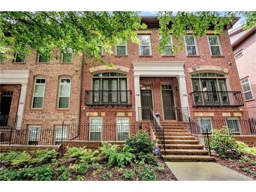 Charming brick townhome with multiple stories, a landscaped front yard, and a welcoming front entrance at 2548 Crescent Park Ct # 7, Atlanta, GA 30339