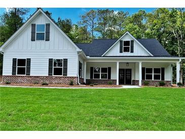 Charming new construction home featuring a manicured lawn and inviting front porch at 8145 Lakeview Pkwy, Villa Rica, GA 30180