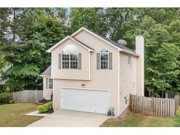 Charming two-story home featuring an attached garage and well-maintained front yard at 503 Fable Ln, Canton, GA 30114