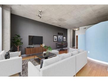 Contemporary living room features sleek furniture, modern decor, and concrete ceilings at 3300 Windy Ridge Se Pkwy # 1107, Atlanta, GA 30339
