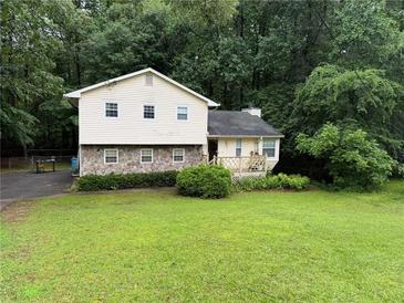 Charming two-story home with stone accents and a well-manicured front lawn at 2523 Bronco Trl, Duluth, GA 30096