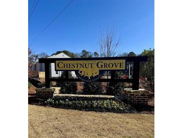 Chestnut Grove: A Starlight Homes community entrance sign with brick base and manicured landscape against a blue sky at 5002 Elowen Ln, Douglasville, GA 30135