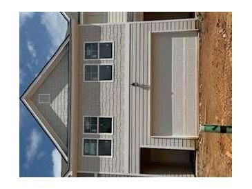 Exterior shot of a two-story house with gray siding and a two-car garage at 1023 Merritt Dr # 100, Villa Rica, GA 30180