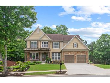 Beautiful two-story home with a well-manicured lawn and mature trees, creating a welcoming curb appeal at 155 Edgewater Trl, Canton, GA 30115