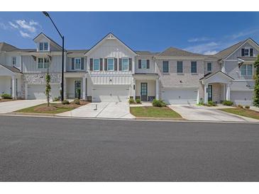 Charming townhome with white siding, a two-car garage, and a well-manicured lawn at 2139 Kirkham Way, Kennesaw, GA 30152
