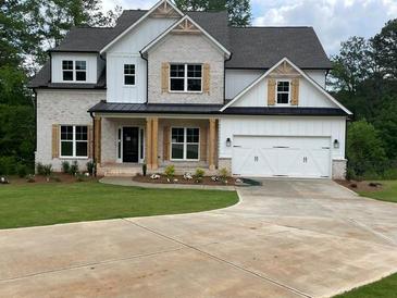 Beautiful two-story home featuring a brick and white exterior and a spacious two car garage at 2021 Shallowford Rd, Marietta, GA 30066