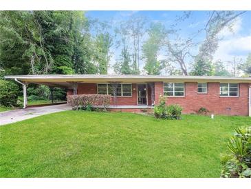 Charming single-story brick home featuring a carport and lush green lawn at 3179 Dogwood Dr, Atlanta, GA 30344