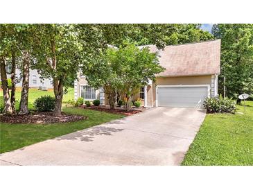 Charming home featuring manicured lawn, two-car garage, and mature trees providing ample shade at 3358 North Ct, Ellenwood, GA 30294