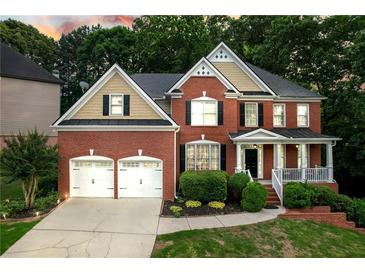 Beautiful two-story brick home with a well-manicured lawn and a two-car garage at 3310 Vista Creek Dr, Dacula, GA 30019