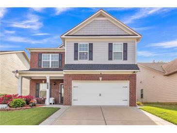 Charming two-story home with brick and siding, well-maintained lawn, and attached two-car garage at 911 Sonoma Dr, Lawrenceville, GA 30045
