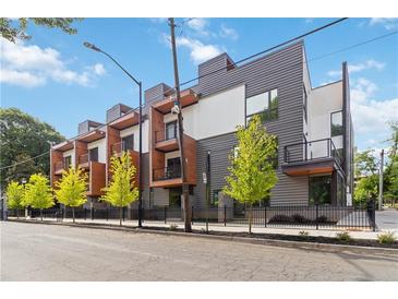 Modern townhomes with stylish gray and white exteriors, accented by wood trim and private balconies at 367 Parkway Ne Dr # 9, Atlanta, GA 30312