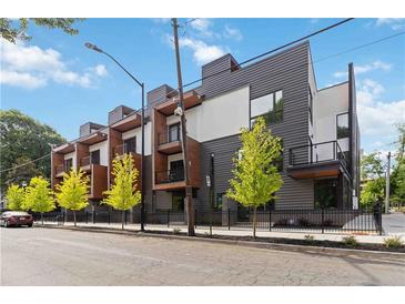 Modern townhome exterior featuring a combination of gray siding, balconies, and professional landscaping at 367 Parkway Ne Dr # 9, Atlanta, GA 30312