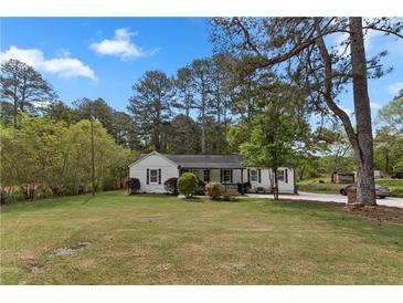 Charming single-story home featuring a well-maintained lawn and inviting curb appeal in a quiet neighborhood at 2014 Fence Rd, Dacula, GA 30019