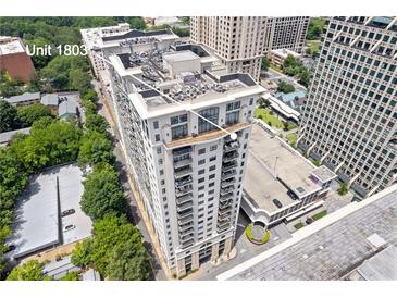 Aerial view of a luxury high-rise condo building with balconies and surrounding cityscape at 3040 Peachtree Nw Rd # 1803, Atlanta, GA 30305