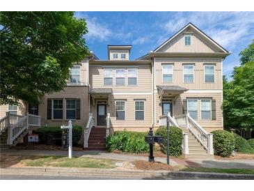 Inviting townhome with charming front porch and well-maintained landscaping in a desirable neighborhood at 4400 Village Field Pl, Suwanee, GA 30024