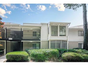 Charming condo with white siding, a balcony, and lush landscaping at 2015 Wingate Way, Atlanta, GA 30350
