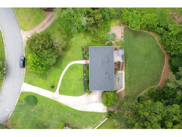 An aerial view of a well-maintained property featuring a lush lawn and mature trees at 388 Talcott Nw Cir, Marietta, GA 30064
