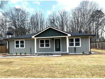 Charming single-story home with a gray exterior, white trim, and a well-manicured front lawn at 487 Eastside Dr, Dacula, GA 30019