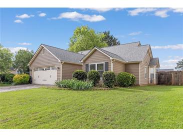 Charming single-story home with well-manicured lawn and attached two-car garage at 1615 Nw Vinebrook Nw Ter, Kennesaw, GA 30144