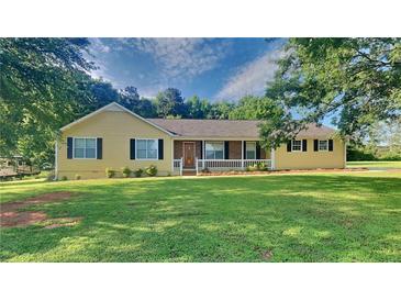 Charming single-story home featuring a well-manicured lawn, inviting front porch, and classic curb appeal at 200 Compton Ct, Mcdonough, GA 30252