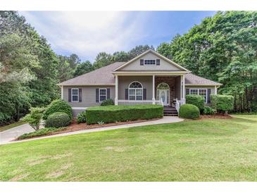 Charming single-story home with a manicured lawn and mature landscaping creating an inviting curb appeal at 408 Gray Fox Dr, Canton, GA 30114