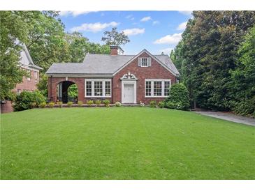 Charming brick home with a lush green lawn and beautiful landscaping at 655 E Pelham Ne Rd, Atlanta, GA 30324