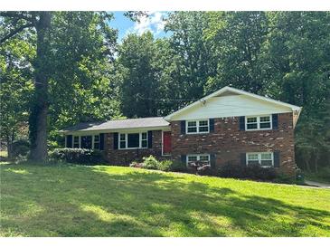 Charming two-story brick home featuring a well-manicured front yard and a classic architectural style at 5669 Hillcrest Dr, Acworth, GA 30102