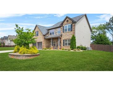 Charming two-story home with a well-manicured lawn and a two car garage at 321 Shannon Ct, Mcdonough, GA 30252