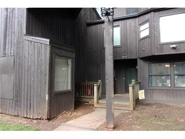 Rustic condo exterior with weathered wood, covered porch, and natural surroundings at 2814 Shellbark Rd, Decatur, GA 30035